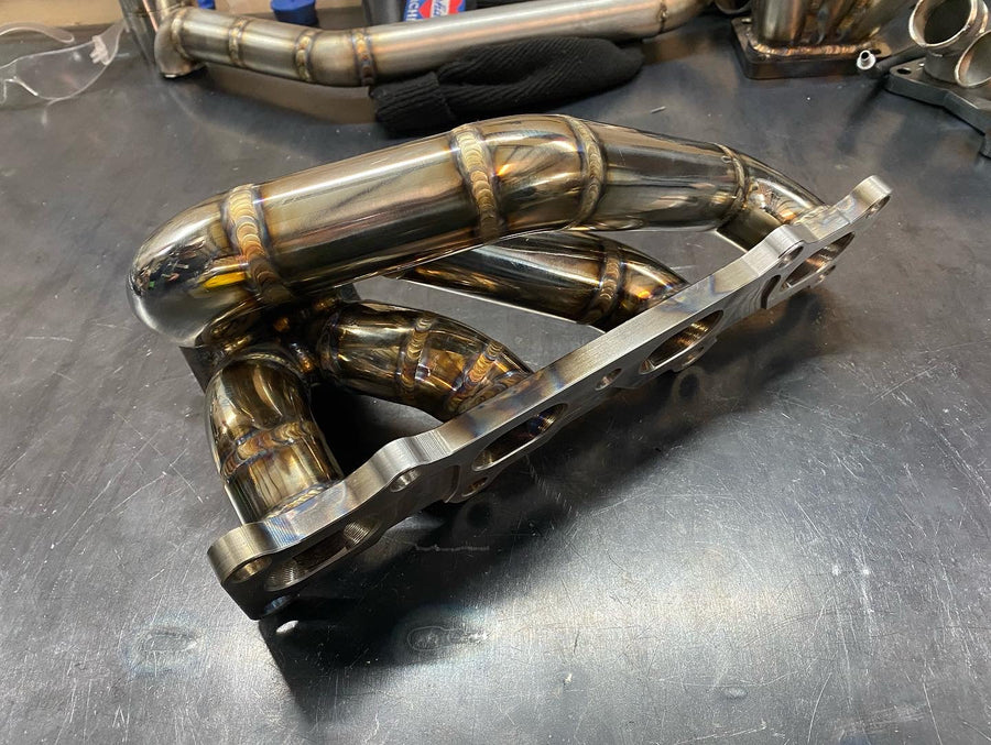 Handcrafted Mazda Miata 1.6L turbo exhaust manifold by DarkLight Fabrication